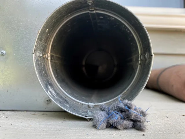 Windham Dryer Vent Cleaning technician using specialized equipment to clear severe dryer vent blockage in Windham